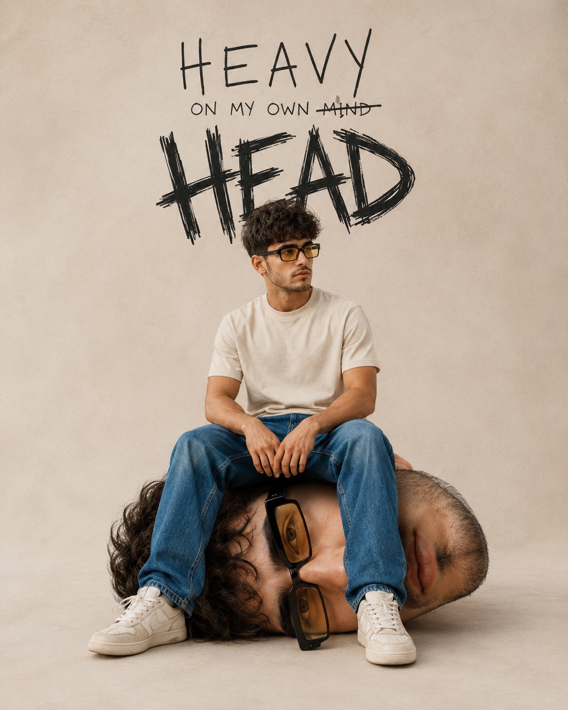 Surreal editorial poster with a young man sitting on an oversized sleeping head under hand-drawn Heavy Head typography.